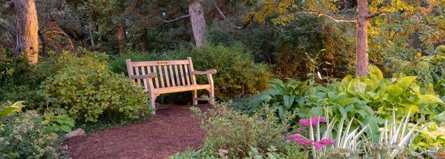 Five-foot teak bench with engraved plaque. 